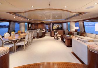 seating area, dining table and bar in the skylounge aboard charter yacht JAGUAR 