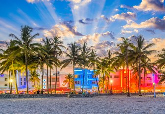 Art deco buildings in South Beach Miami lit up as the sun begins to set