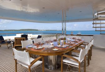 alfresco dining table on the upper deck aft of charter yacht ODESSA 