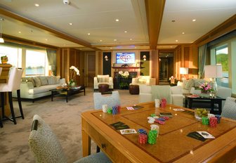 skylounge with sofas, bar and games table on board motor yacht UTOPIA 