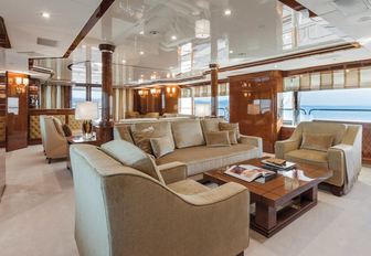 sofas and armchairs create a lounge area in the main salon of superyacht CHECKMATE 