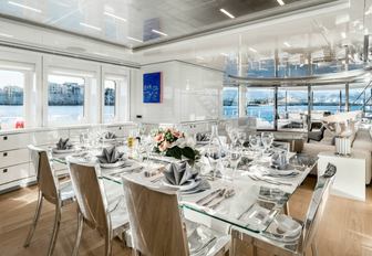 sleek and stylish formal dining area in main salon of motor yacht Her Destiny