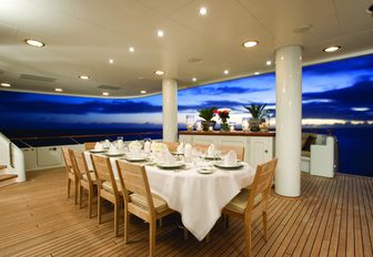 alfresco dinning area set up for dinner aboard superyacht UTOPIA 