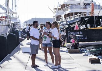 attendees chat on the boardwalks on the Antigua Charter Yacht Show