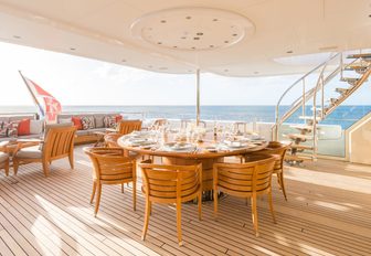 al fresco dining table on the upper deck aft of luxury yacht HANIKON 