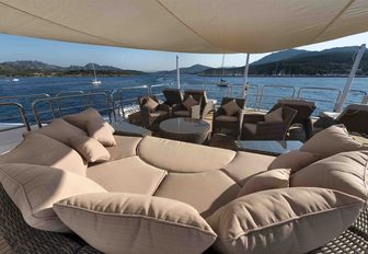 sunpads and seating under Bimini on sundeck of luxury yacht Mine Games 