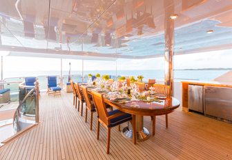 large al fresco dining area on the upper deck aft of charter yacht Lady Joy 