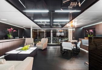 laid back skylounge with seating, bar and games area on board motor yacht GIRAUD