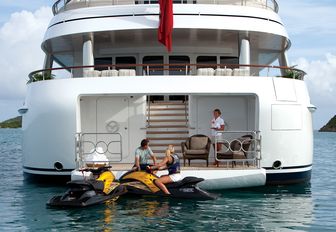 charter guests access the jet skis from the swim platform aboard motor yacht MAJESTIC 