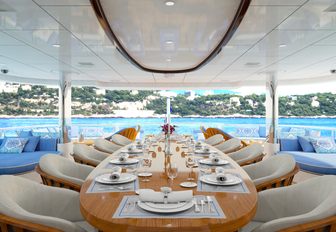 large alfresco dining table on the upper deck aft of luxury yacht My Seanna