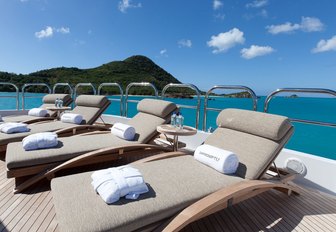 teak loungers lined up on the sundeck of motor yacht IMPROMPTU 