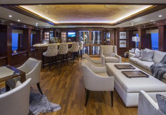 warm and welcoming skylounge with sumptuous seating, games table and bar aboard motor yacht BACCHUS 