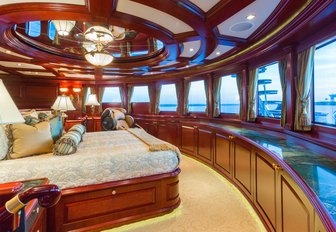 master suite with dark woods and 180-degree views on board motor yacht ‘Amarula Sun’ 