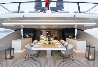 A table and chairs on the upper deck of superyacht Seven Sins