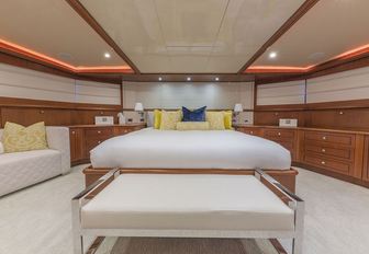 the bright and capacious master  cabin inside charter yacht GOTA with kingsized bed, lounging space, and ample storage