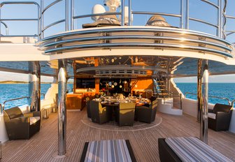 circular dining table on the upper deck aft of charter yacht Remember When