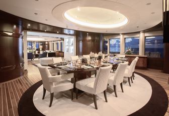 Dining table set for 8 guests in main salon of superyacht Dream
