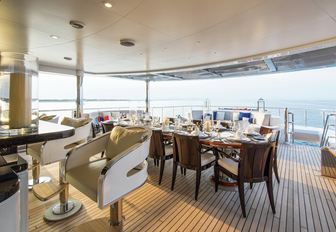 al fresco dining table and bar on board superyacht Excellence V