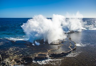 Powerful waves crashing into the reef, the famous Mapu'a 'a Vaea blowholes in Tonga