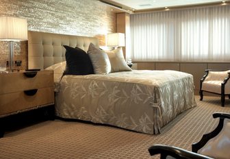 bed and mother-of-pearl headboard in master suite aboard motor yacht MAJESTIC 