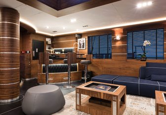 bar area with tall bar stools in main salon of superyacht ‘Rox Star’ 