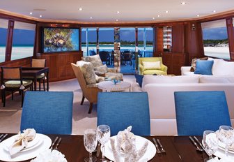 well-equipped main salon with formal dining table and comfortable lounge area on board superyacht ‘Second Love’ 