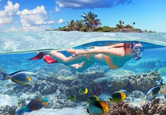 Girl scuba diving in clear waters of the Caribbean