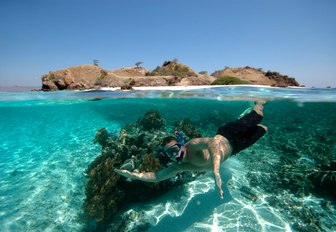 charter guests goes snorkelling in the crystal clear waters of Komodo