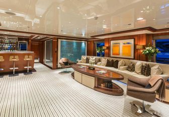 light and airy skylounge with long sofa and bar on board luxury yacht Sequel P