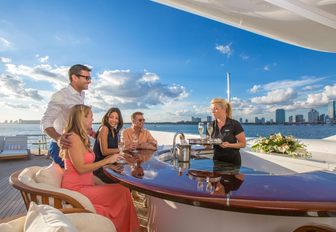 guests served drinks on the deck of superyacht Lady Joy while on a Miami yacht charter