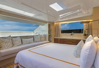 the master stateroom of luxury yacht freddy overlooking the bahamian coast via the panoramic window set up