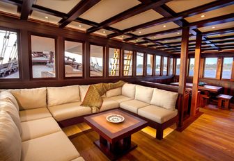 u-shaped sofa in the main salon of sailing yacht Dunia Baru 