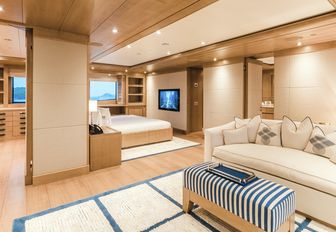 seating area and large bed in the master suite on board superyacht Ramble on Rose 