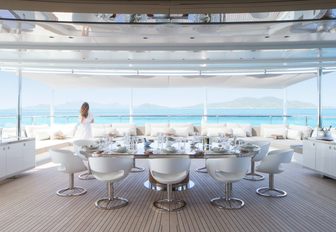 shaded al fresco dining area with a charter guest on board motor yacht NAUTILUS