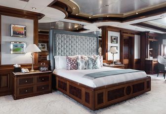 elegant master suite with rich wood joinery and large bed on board superyacht TITANIA