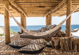 hammock and shaded loungers at Scorpios beach club in Mykonos, Greece 