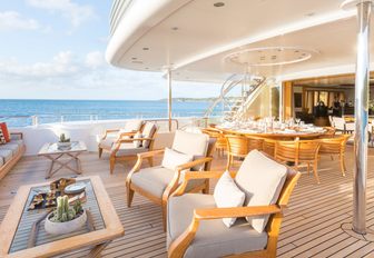 outdoor seating and dining area on the upper deck aft of superyacht HANIKON 