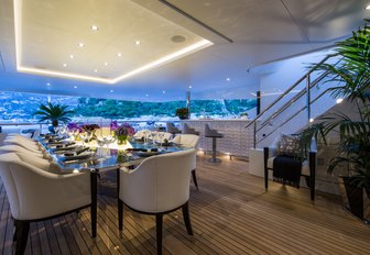 al fresco dining table and bar on the upper deck aft of charter yacht 11/11 