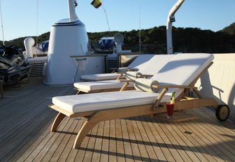 sun lounger with a cocktail on sundeck of charter yacht ‘Heavenly Daze’