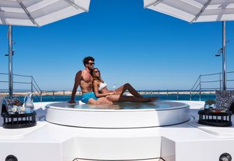 charter guests relax in the Jacuzzi on the foredeck of luxury yacht 11/11 