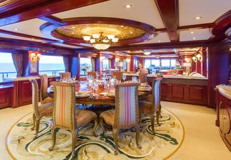 circular dining table provides a formal place to dine in the main salon of luxury yacht Amarula Sun 
