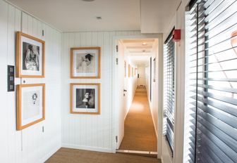 black and white photos hang up throughout the interior of charter yacht MENORCA 