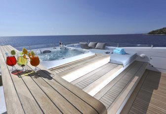Jacuzzi and cocktails on sundeck of motor yacht OURANOS