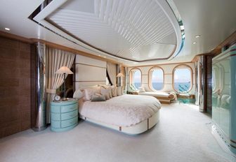 master suite with large oval windows on board charter yacht huntress