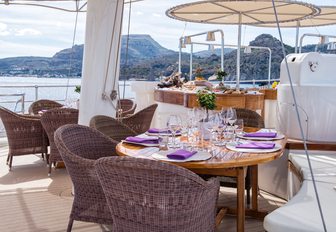 table is laid out for an alfresco dinner on board superyacht SHERAKHAN
