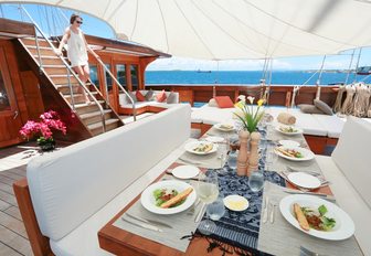 dinner is served in the al fresco dining area on board luxury phinisi LAMIMA 