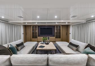 U-shaped sofa faces a large TV in the skylounge aboard luxury yacht Liquid Sky 
