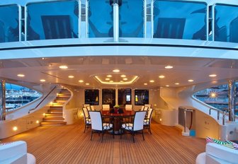 alfresco dining around a circular table on upper deck aft of superyacht ULYSSES 