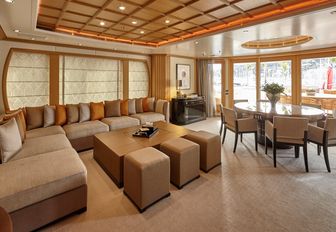 huge L-shaped sofa and table in full-beam upper salon on superyacht HANIKON 