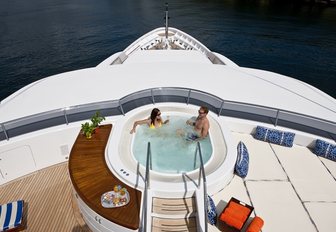 overhead view of charter guests relaxing in sundeck Jacuzzi aboard super yacht 'Blue Moon'